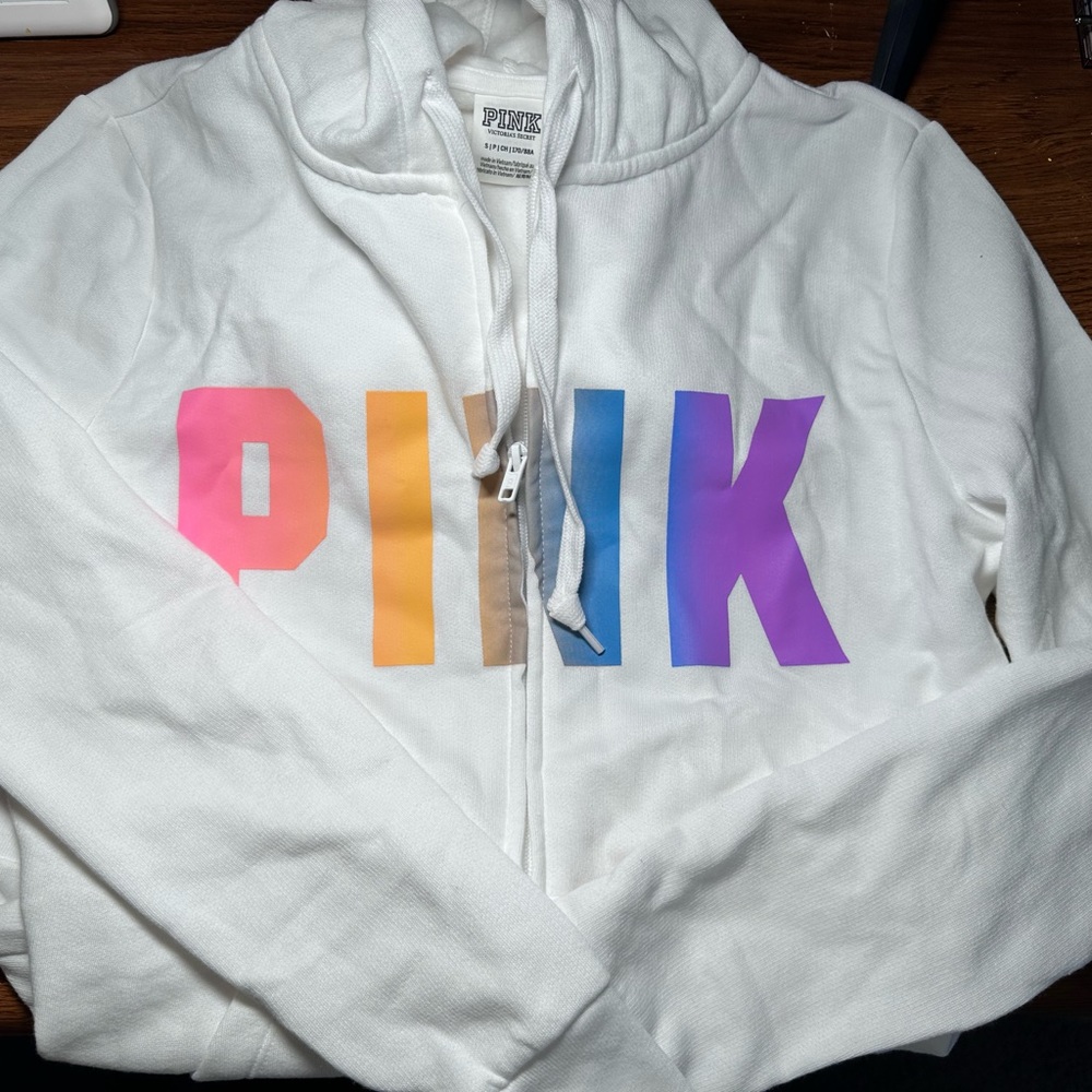 PINK Brand white hoodie, with rainbow logo across zip front.